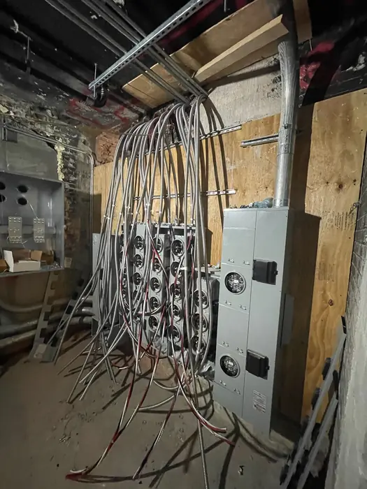 Conduit runs and panel enclosures roughed in before finish work