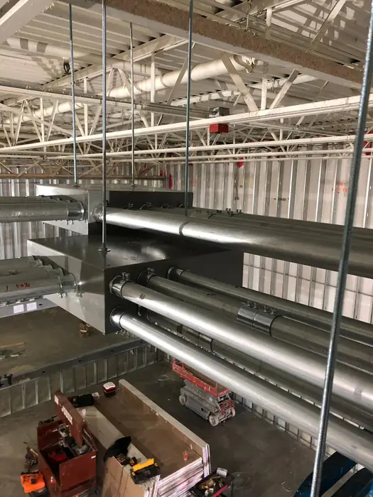 Large-diameter conduit run through a commercial building under construction