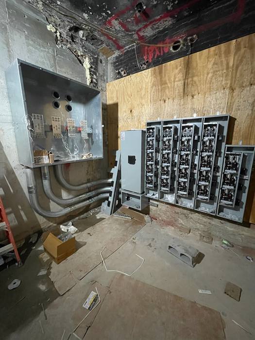 Commercial electrical room with meter stacks and conduit runs