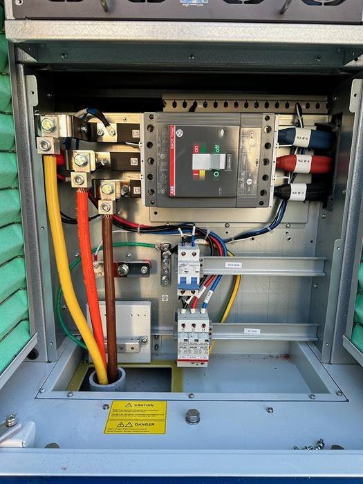 Commercial switchgear cabinet showing main breaker, terminations, and control wiring