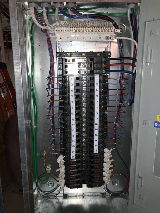 Open electrical panel with neatly organized branch circuit wiring and labeled breakers