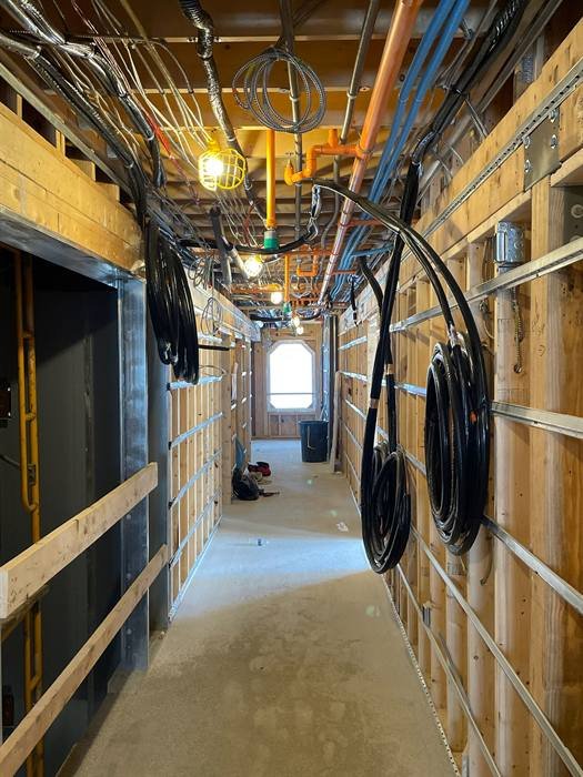 Electrical rough-in conduit and wiring in a corridor under construction