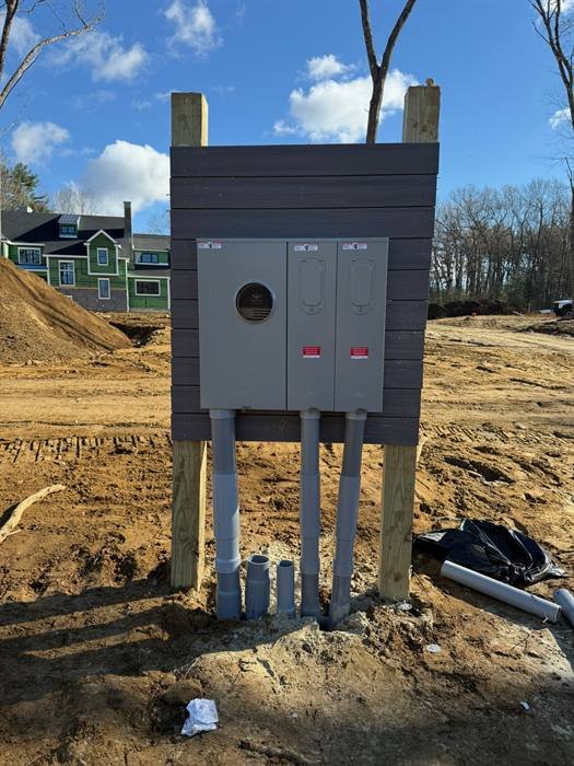 Electrical service equipment installed on a stand at a new construction site
