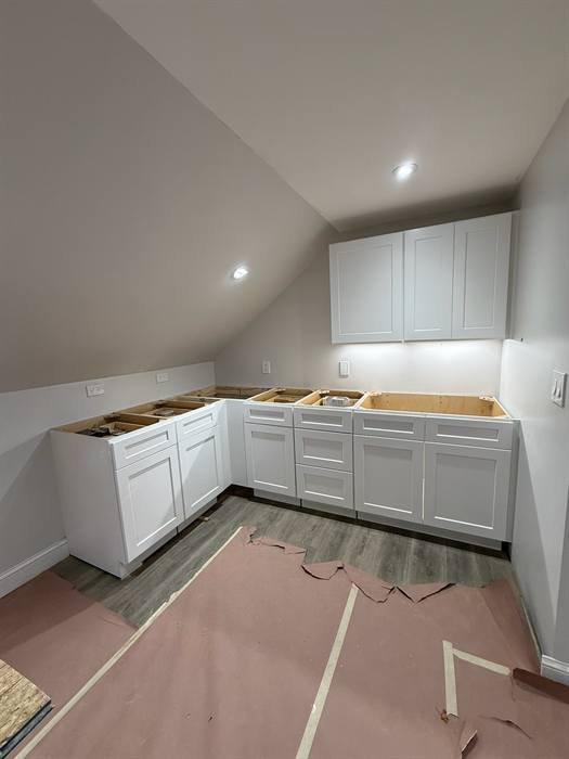 Recessed lighting installed in a finished interior with cabinetry