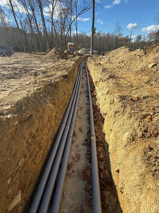Long trench with conduit installed for an underground electrical service run